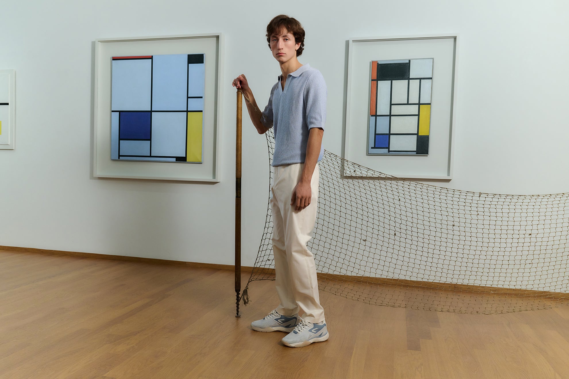 The ACE Hub OC sneaker in sea ice white, photographed in an art museum with Mondrian paintings