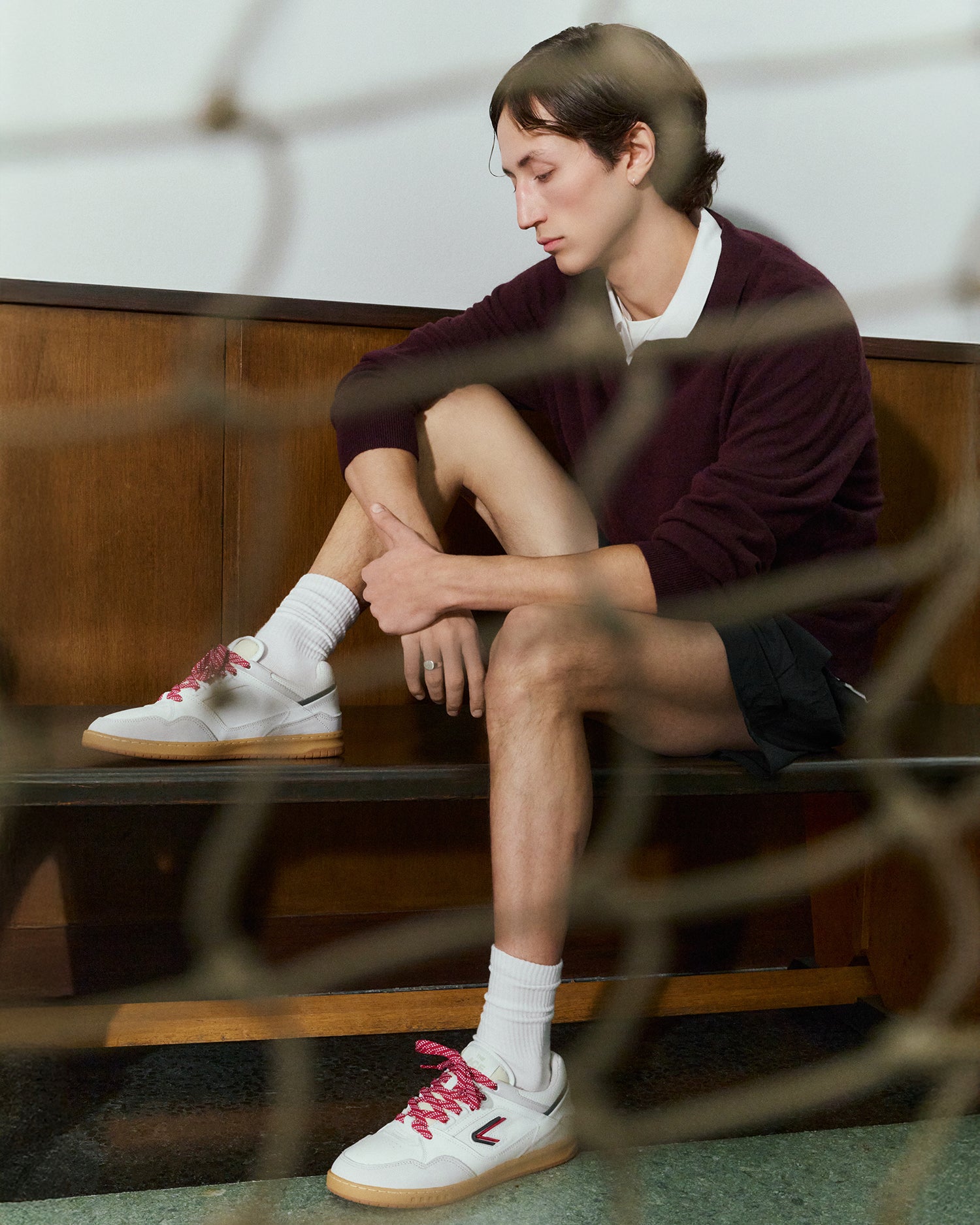 The ACE Hub Sprint sneaker in white with red retro-style laces, photographed in an art museum