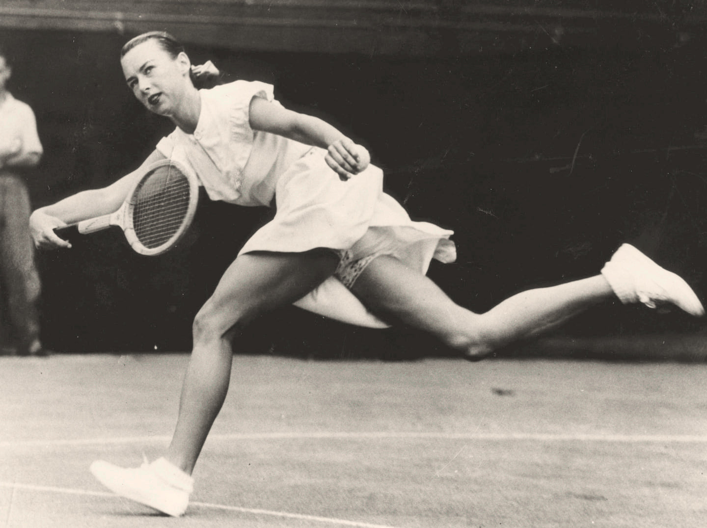 Gussy Moran playing at Wimbledon in 1949, wearing her iconic lace-trimmed tennis outfit

